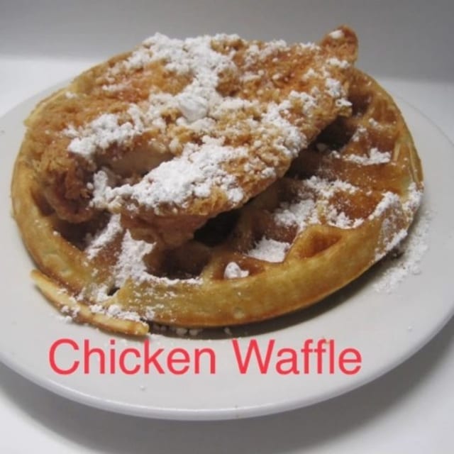 Chicken Waffle Dusted with Powdered Sugar.