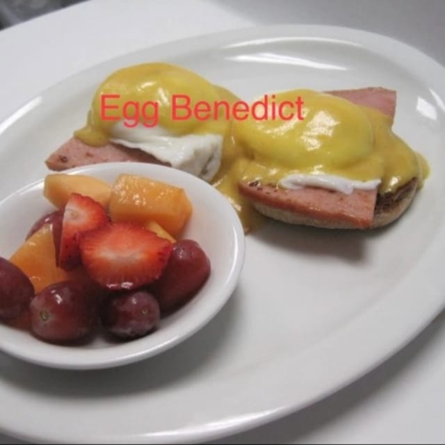 Ham Benedict with fruit cup.