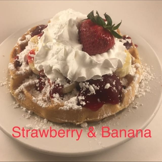 3 Fresh & Strawberry Syrup, Banana Pancakes Whipped Cream and Dusted with Powdered Sugar.