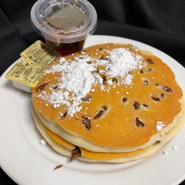 3 Chocolate Chips Pancakes Dusted with Powdered Sugar.