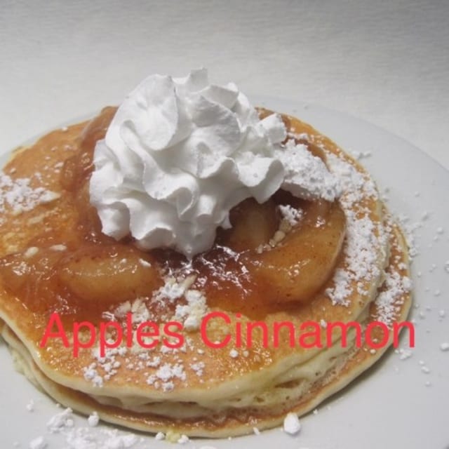 3 Apple Cinnamon Pancakes Whipped Cream & Dusted with Powdered Sugar.