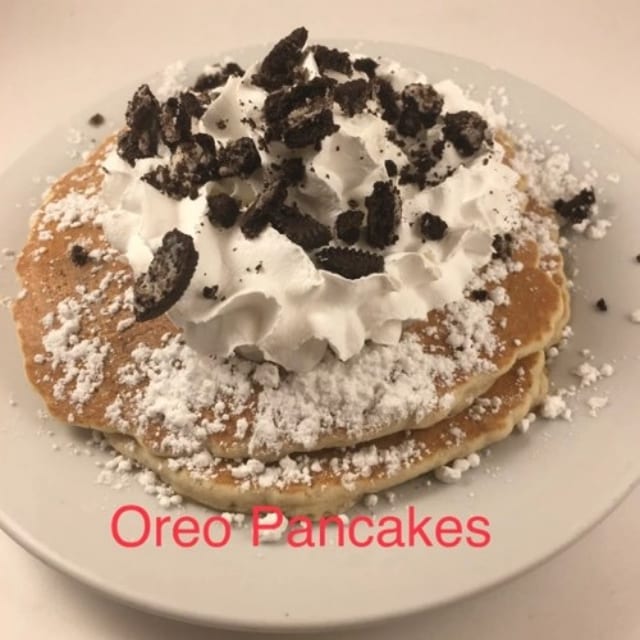 3 Oreo Pancakes Whipped Cream and Dusted with Powdered Sugar.