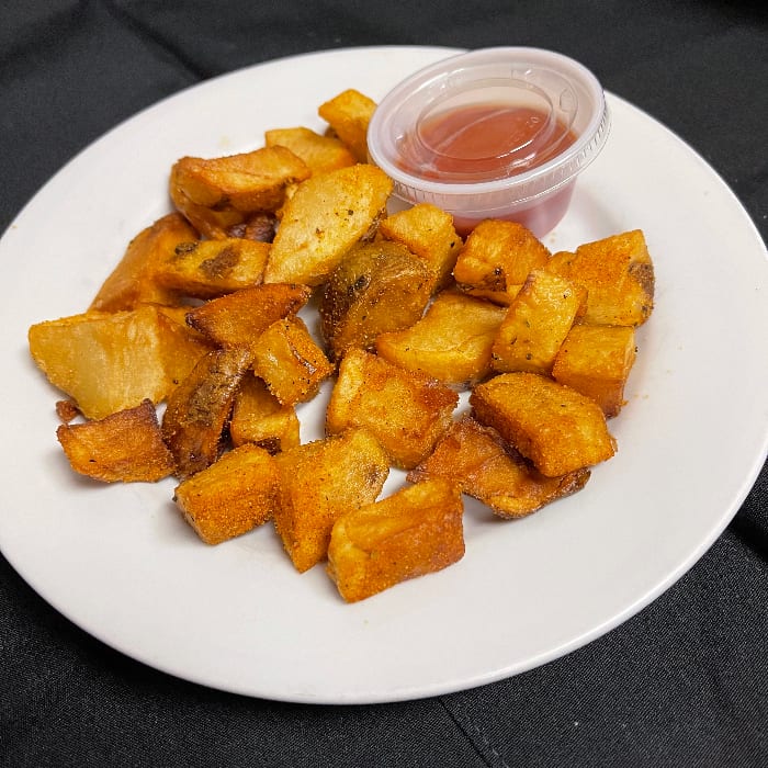 Home fries with ketchup.